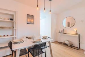 a dining room with a white table and chairs at 2 BR house w/ terrace, near train stations & metro in Lille