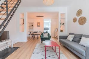 a living room with a couch and a table at 2 BR house w/ terrace, near train stations & metro in Lille