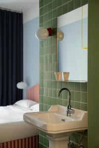 a bathroom with a sink and a bed and a mirror at Armesto Rooms in Madrid