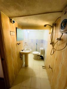 a small bathroom with a sink and a toilet at Knuckles bungalow in Rattota