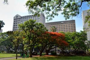 a large building with trees in a park at Hyatt Regency Harare The Meikles in Harare