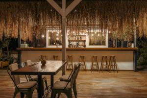 a restaurant with a table and chairs and a bar at Boho Garden Selimiye in Selimiye