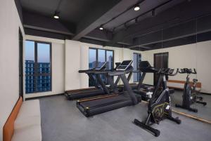 a gym with treadmills and ellipticals in a building at Days Inn by Wyndham Hangzhou Zhuantang in Hangzhou