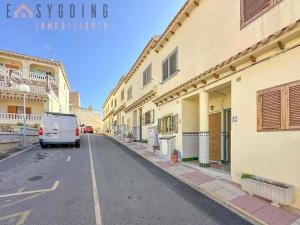 a van parked on a street next to buildings at Casa Blanca 1 in Santa Pola