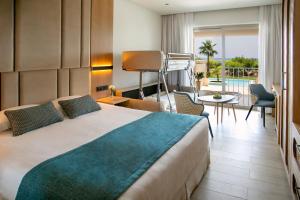 a hotel room with a bed and a balcony at Asterias Beach Hotel in Ayia Napa