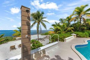 a resort with a swimming pool and the ocean at Gypsy Villa home in Driftwood Village