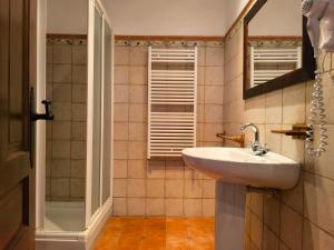 a bathroom with a sink and a shower at Masia Del Cura in Rubielos de Mora