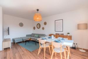 a living room with a table and chairs and a couch at Quiet 1 bedroom apartment parking Old Lille in Lille