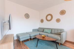 a living room with a couch and a table at Quiet 1 bedroom apartment parking Old Lille in Lille