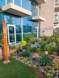 a garden in front of a building at Spacious, Economical Apt Near Miralcz Garden in Dubai