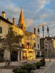 a building with a clock tower on top of it at GRADISSIMO in Grado-Pineta