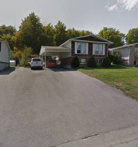 una casa con un coche aparcado en la entrada en Studio 5 mins to Water in Elliot Lake, Ontario, en Elliot Lake