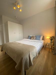 Un dormitorio con una gran cama blanca y una mesa en Ann's Apartment, en Białystok