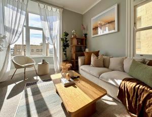 a living room with a couch and a table at Cozy, Bright and Best Value Gem at Potts Point - 2 km to Sydney CBD in Sydney