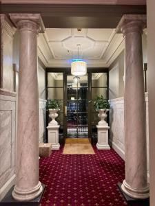 a hallway with two columns in a building at Cozy, Bright and Best Value Gem at Potts Point - 2 km to Sydney CBD in Sydney