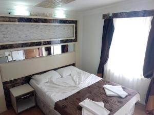 Postel nebo postele na pokoji v ubytování Behram Hotel