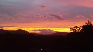 a sunset with mountains in the background at Pousada Hang Conectada com a Natureza in Florianópolis