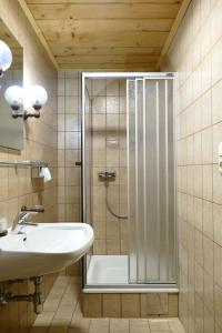 a bathroom with a shower and a sink at Pension DORFPLATZL Pitztal in Plangeross