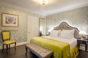 a bedroom with a large bed and a chair at Stanhope Hotel by Thon Hotels in Brussels