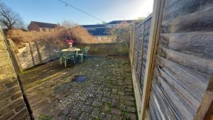 a backyard with a table and a fence at Cosy Villa- 5 Bedroom Accommodation Great For Longer Stays!!! in Chatham