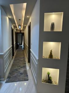 a hallway with plants on the wall at Luxurious apartment in cairo in Cairo
