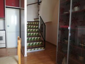 a staircase in a kitchen with green and white at Roses, Puig Rom in Roses