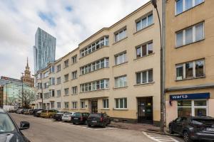 una calle con coches estacionados frente a un edificio en Luxury Apartments in the City Center en Varsovia