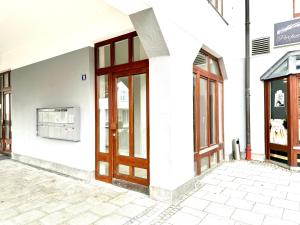 a store front with wooden doors on a building at E&K living - city central - design apartment - kitchen - free parking in Gersthofen