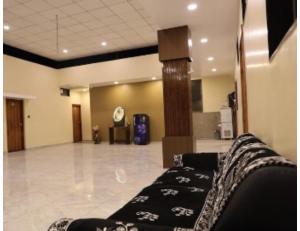 a lobby with a couch in the middle of a room at Hotel The Pill, Bhavnagar in Bhavnagar