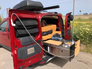a red van with its back open with the back door open at Dacia Dokker Camperiz in Palma de Mallorca