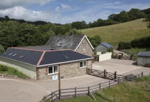 an image of a house with a solar roof at Mincombe Barn Bed & Breakfast in Sidbury