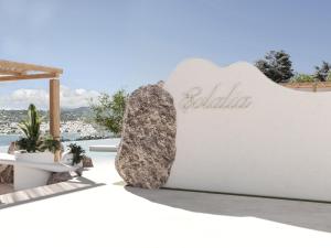 a rock sitting on the side of a sign at Evlalia Studios & Villas in Skopelos Town