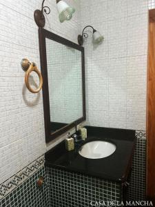 a bathroom with a sink and a mirror at Habitacion de los molinos in Mota del Cuervo