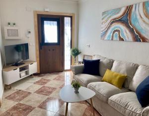 sala de estar con sofá y mesa en Casa encantadora y confortable en Málaga. en Málaga