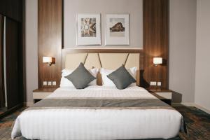 En eller flere senge i et værelse på Dream Residence Rawabi-دريم رزيدنس الروابي