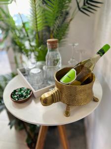 a table with a bottle of champagne and a bowl ofellery at Butik Life Hotel & Apartments in Budapest