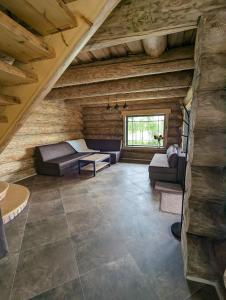 a large living room in a log cabin at Brīvdienu māja "Saules Avoti" in Talsi