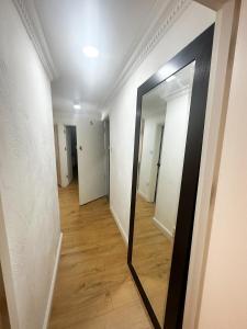 a hallway with a mirror on the wall at Flat 4, Stay in Aldgate in London