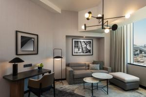 a living room with a couch and a table at Sheraton Mall of the Emirates Hotel, Dubai in Dubai