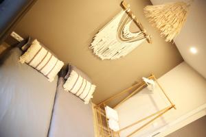 a bedroom with a bed with white pillows and a mirror at L'appart Baobab, avec sauna in Liège +28 photos