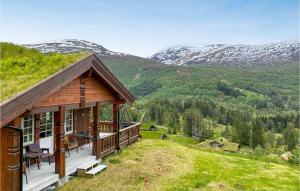 a log cabin with a view of the mountains at 4 Bedroom Awesome Home In Nordfjordeid in Nordfjordeid
