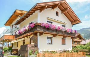 a house with flowers on the balcony at Ferienhaus - Uderns in Uderns