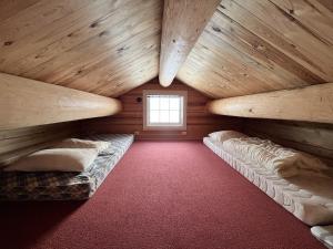a room with two bunk beds in a log cabin at Sletthovdun 151 in Al