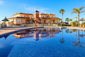 a villa with a swimming pool in front of a house at Malibu Mansions with private hot tub in Mijas Costa