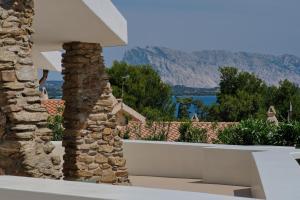 a view from a house with a stone wall at Amoreddu in San Teodoro