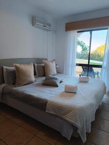 a large bed in a room with a large window at Jardim de Mar in Carvoeiro +23 photos