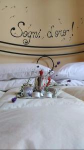 a tray with a tea set on a bed at Agriturismo Nonna Luisa in Ferentino