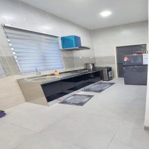 a kitchen with a sink and a counter top at Family Homstay kulim Hitech in Kampong Sira