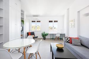 a living room with a table and a couch at Apartamentos Bravo by A3 Rentals in Granada