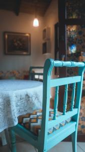 a blue chair with a table in a room at Casa Mico Leão Dourado in Bombinhas